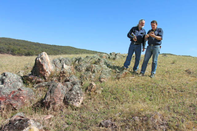 Kempfield site manager Brian Horspool (left) and Chief Geologist Dr. Vladimir David (right) with Causeway altered rock outcrop in foreground
