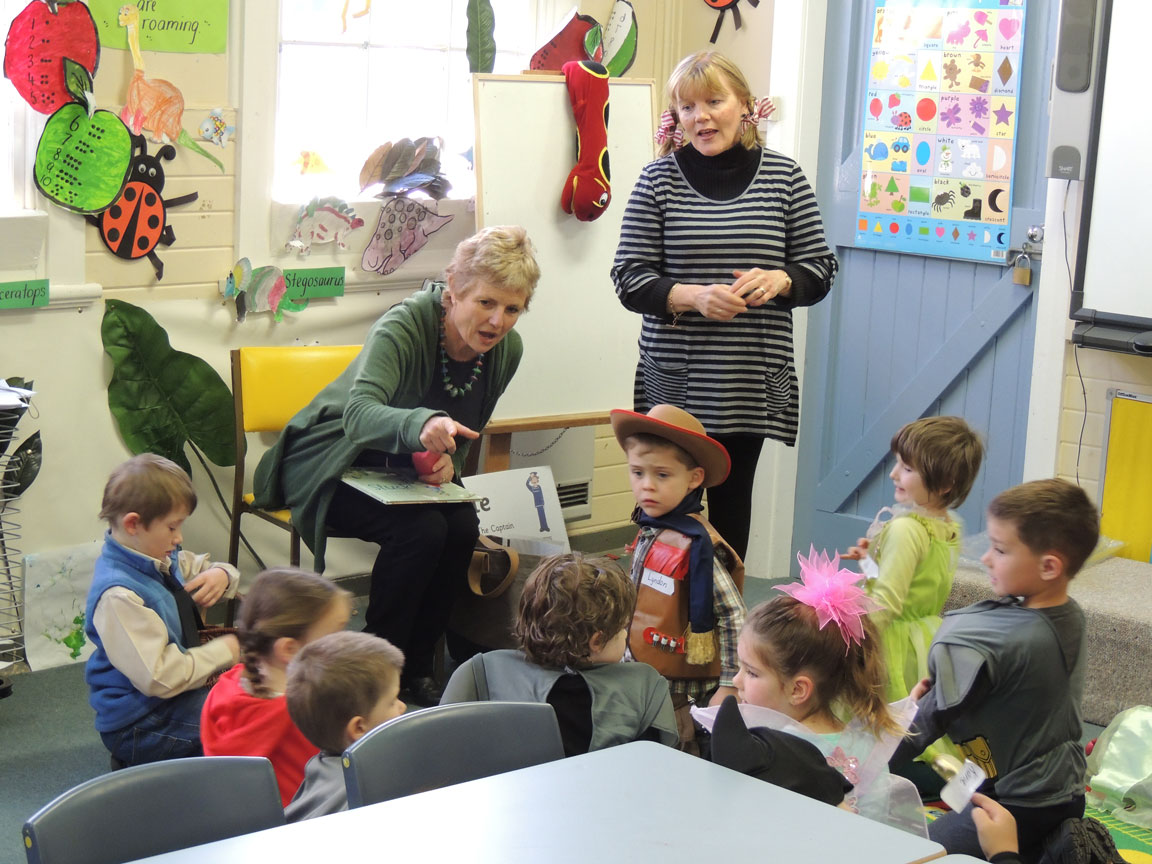 Author Charlotte Calder (seated) gives the children some tips on story telling