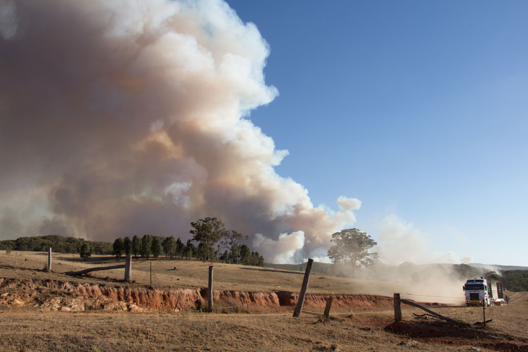 Smoke from the Hells Hole fire rises threateningly above the parched landscape